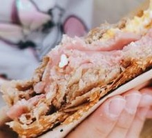 Braised flatbread with sausage and egg
