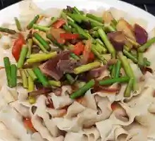 Garlic Shoot Stir-Fry with Pork over Noodles