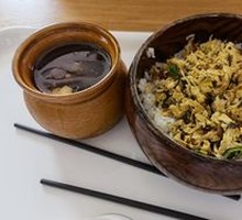Grandmother's Vegetable Stir-Fry with Egg in Wooden Bowl Rice