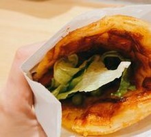 Egg-filled pancake with grilled sausage