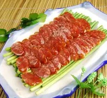 Stir-fried garlic shoots with Sichuan-style cured sausage