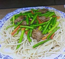 Garlic Shoot Stir-Fry with Pork over Noodles