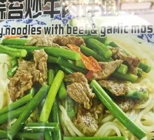 Garlic Shoot Stir-Fry with Pork over Noodles
